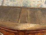a small wooden chest with a drawer on top of it