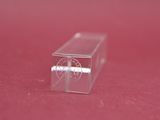 a small clear box on a red surface