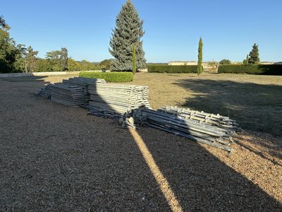 a pile of wood sitting in the middle of a field