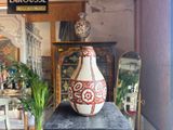 a vase sitting on top of a table in a room