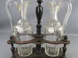 two glass vases sitting on a wooden stand