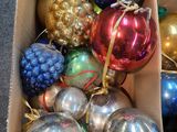 a box full of christmas ornaments sitting on the floor