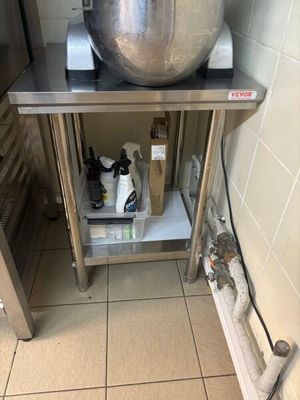 a large metal bowl on a stand in a kitchen