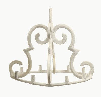 a white sculpture of a bird on a stand