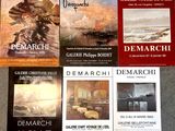 several books on a table with a painting of a ship in the background
