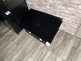 a black tv sitting on top of a wooden floor
