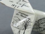 a white origami paper origami with a drawing on it