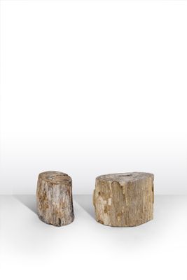 two pieces of wood sitting next to each other on top of a white surface