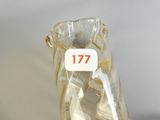 a glass vase with a label on it that says 777