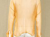 a mannequin wearing a yellow shirt and white pants