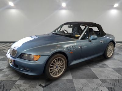 an image of a blue sports car parked in a garage