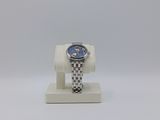 a close up of a watch on a stand on a white surface