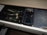 a drawer full of silverware and utensils in it