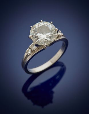 an engagement ring with a round brilliant cut diamond set in 18k white gold