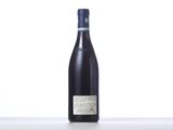 a bottle of wine sitting on top of a table next to a bottle of wine