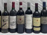 several bottles of wine are lined up on a table