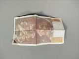a folded up piece of paper with a picture of a man on it