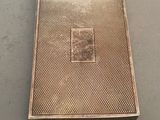 an antique silver cigarette case with a picture of a man on it