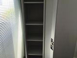 a white cupboard with a door open in a room