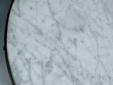 a white marble table with a black metal base