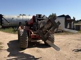 a tractor that is parked on the side of the road