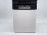 a white and black air purifier sitting on top of a white table