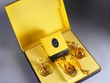 a yellow box with three bottles of perfume in it