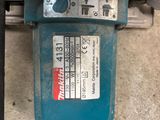 a close up of a blue machine on the ground