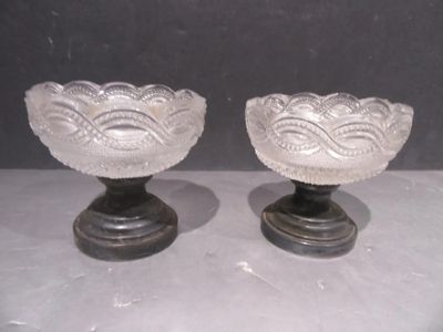 two glass bowls sitting on top of each other