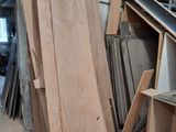 several pieces of wood are stacked on top of each other in a garage