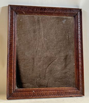 an old wooden picture frame with a brown background on a white wall
