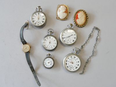 many different types of pocket watches on the table