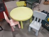 three chairs and a table in the middle of a room