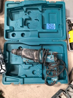 a blue box with a drill and other tools in it