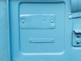a close up of a blue metal door with a latch