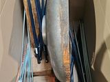 a box with a bunch of brushes and a broom in it