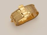 an image of a gold bracelet with a cross on it