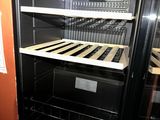 an image of an open refrigerator with shelves in a kitchen