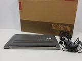an open laptop computer sitting on top of a table next to a box