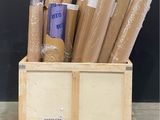 many rolls of brown paper sitting in a wooden crate
