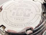 a close up of a person holding a watch in their hand