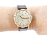 a woman that is wearing a watch on her wrist