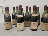 six bottles of wine are lined up in a row on a table