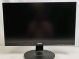 the monitor is on a stand on a white surface