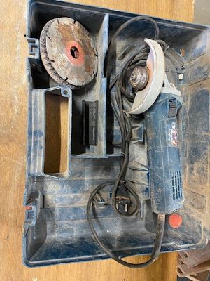 a box that has a drill and other tools inside of it