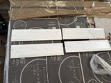 four pieces of marble sitting on top of a cardboard box