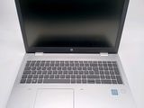 an open laptop computer sitting on top of a white table