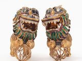pair of gold and enamel foo foo foo figurines on wheels