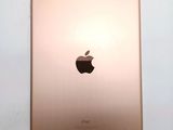 an image of a close up of a gold ipad on a white surface