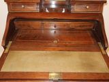 a wooden desk with a mirror on top of it